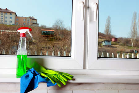Cleaning window using tools - rag and spray detergent. Spring cleaning concept