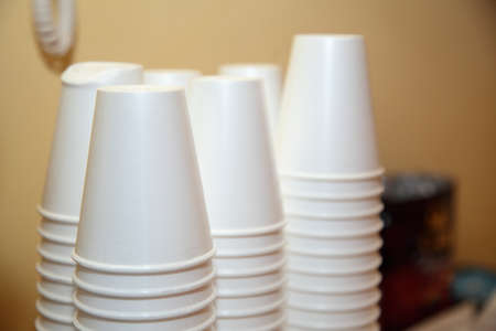 Disposable plastic kitchen utensils pile stack cups on table