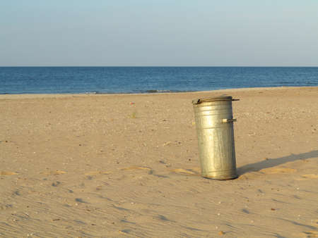 Gray old metal garbage bin or trash can on  beach outdoorの写真素材