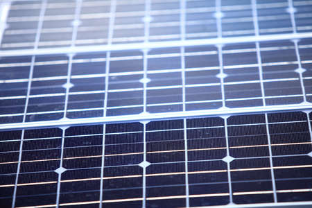 background of blue solar photovoltaic panels, charging batteries. Renewable eco energy concept