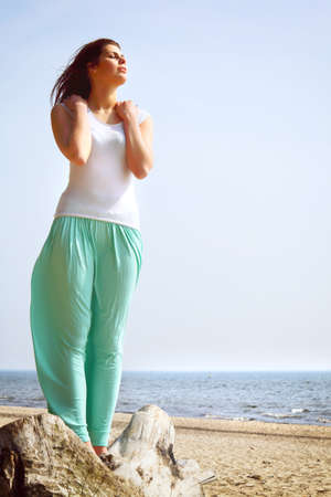 young woman on beach enjoying summer holidayの写真素材