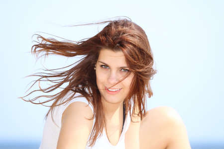 Closeup portrait of beautiful young woman resting at beach in summerの写真素材