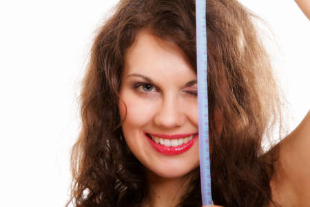 Weight loss young sporty fitness woman with measure tape isolated on white backgroundの写真素材