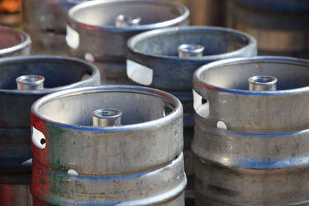Lots of metal barrels beer kegs at factory breweryの写真素材