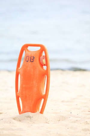 red plastic buoyancy aid in the sandの写真素材