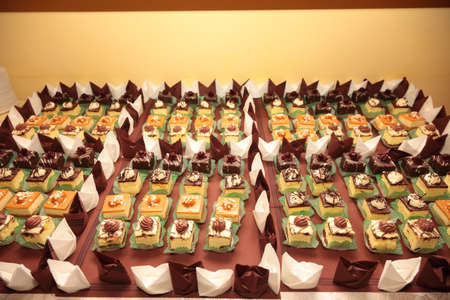 Varieties of cakes individual decorative desserts on the table at a luxury event, gourmet catering sweetsの写真素材