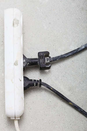 electrical cords connected to a power strip or extension block in construction site