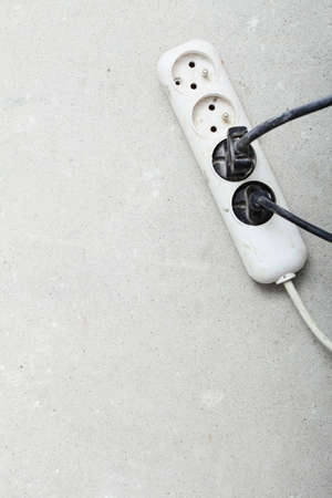 electrical cords connected to a power strip or extension block in construction siteの写真素材