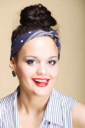 Portrait of young beautiful girl retro style fancy make-up hair bun brown background