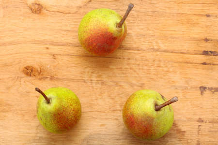 Three pears fruits on old wooden table background. Healthy food organic nutritionの写真素材