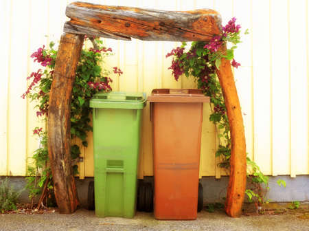 Two industrial trash garbage dust bins on the street flower decoration scandinavia europeの写真素材