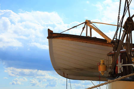 Old wooden lifeboat on a ship