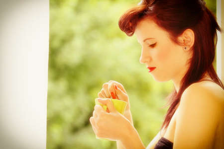 Beautiful Girl Retro Style Drinking Tea or Coffee. Indoor. Cup of Hot Beverage. 