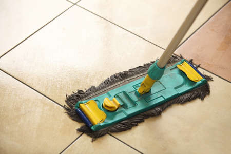 cleaning the floor with a old mop, moppingの写真素材