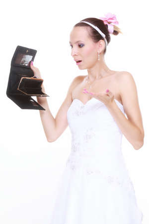 Marriage and money concept of high wedding cost. Bride with empty purse looking surprised isolatedの写真素材