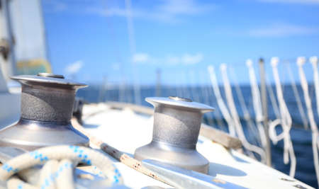 Winch with rope on sailing boat. Yachting yacht in blue baltic sea sunny day summer vacation....