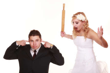Wedding couple having argument - conflict, bad relationships. Angry woman fury bride and groom in fight. Isolated on whiteの写真素材