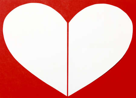 White heart paper on red background. Valentine's Day or holiday greeting card. Heart shape symbol frame.の写真素材
