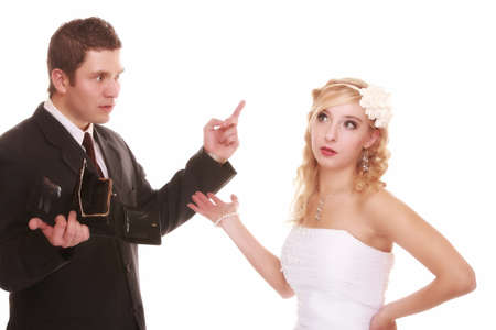 Marriage and money concept of high wedding cost. Angry groom with empty purse bride looking surprised. Bad relationship conflict quarrel isolatedの写真素材