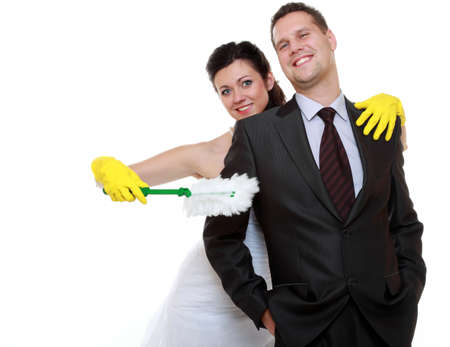 Humorous funny young couple bride groom in domestic role, sharing household chores. Woman with...