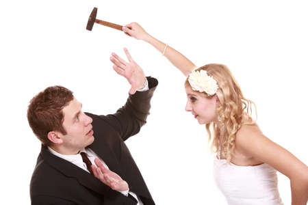 Wedding couple having argument - conflict, bad relationships. Angry woman fury bride and groom in fight. Isolated on whiteの写真素材