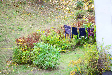 clothes hanging to dry on a laundry line outdoor autumn sceneryの写真素材