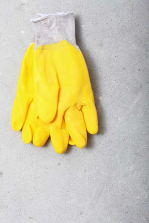 Renovation at home. Construction equipment tools yellow protective work gloves in building site.