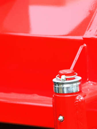 Screw bolt on red machine nut at surface of steel plate detail of industrial machineryの写真素材