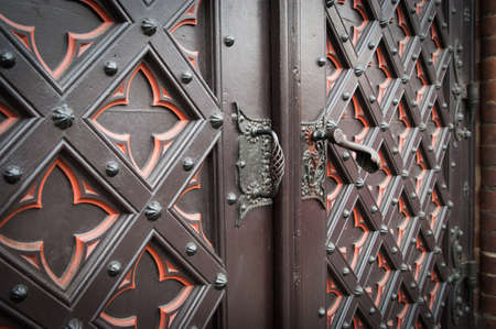 detail part of decorative old wooden church door with ornamentの写真素材