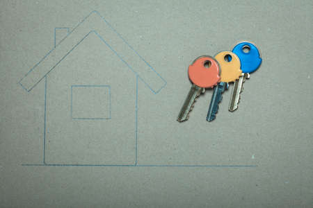 Hand drawn sketch house on recycled paper home symbol and colorful keys, real estate business & building concept.の写真素材