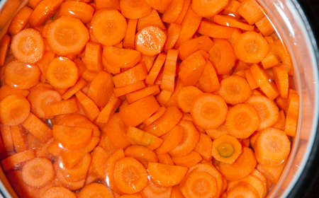 Close up sliced carrots vegetables in water. Healthy diet, organic nutrition.