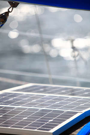 Solar charging batteries aboard a sail boat. Photovoltaic panels renewable eco energy concept