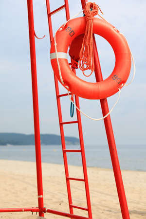 Beach life-saving. Lifeguard rescue equipment orange lifebuoy buoyancy aidの写真素材