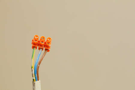 Electrical installation electric socket wires with terminal blocks hanging on wall construction building site copy spaceの写真素材