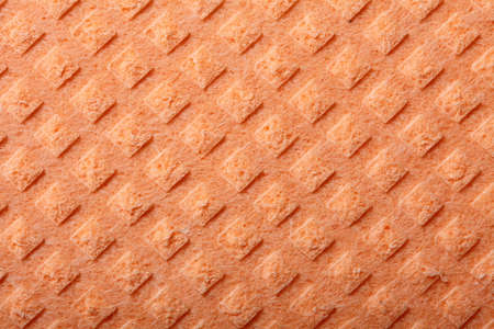 Orange kitchen sponge rubber foam as background textureの写真素材