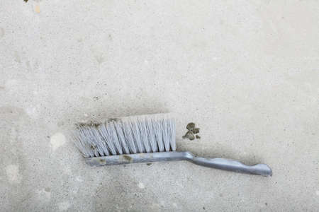 Improvement renovation at home. Blank concrete house floor with broom, construction building siteの写真素材