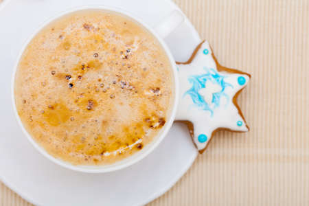 White cup of hot beverage drink coffee cappuccino latte with homemade gingerbread cake star  Christmas  Holiday concept の写真素材
