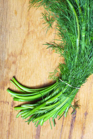 bunch fresh green dill herb on wooden old tableの写真素材