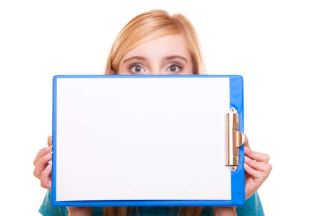 Student blank banner sign. Blonde girl female college student holding and hiding behind clipboard...