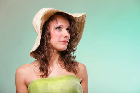 Beautiful smiling spring or summer woman in hat. Green conceptの写真素材