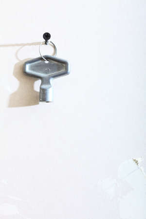  one little winding key used for clock and toys on wall copy spaceの写真素材