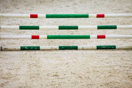 Equitation. Green red white obstacle for jumping horses. Riding competition. Real.の写真素材