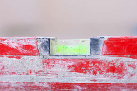 Close up red balance spirit building level in construction site