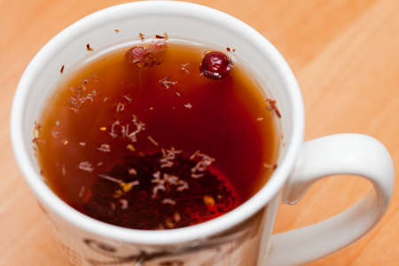 cup of herbal or fruits tea, hot beverage on wooden table backgroundの写真素材