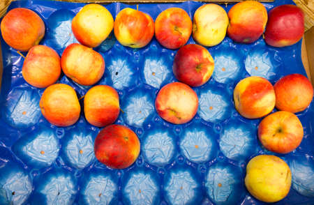 Apples fruits in blue box for sale, supermarket as food backgroundの写真素材