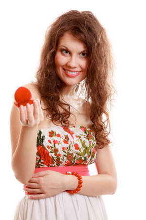 Surprised girl holding red heart shaped box with engagement ring. Young woman with valentine present. Isolated. Studio shot.の写真素材
