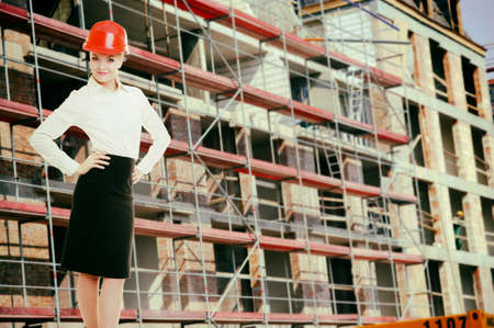 Attractive female engineer working  Woman architect in red safety helmet on construction site  Building の写真素材