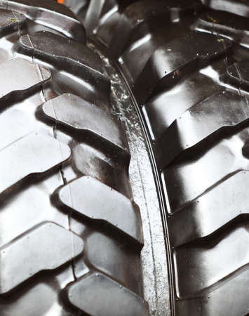 Detailed view of heavy vehicle rubber tire tread texture of a new tractor or other construction...