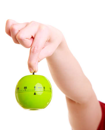 Closeup of female hands  Housewife or chef in colorful kitchen showing apple timer eggtimer isolated studio shotの写真素材