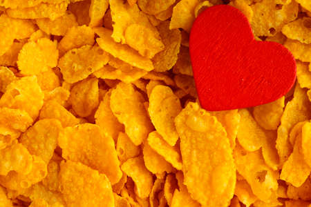 Health and diet concept, healthy breakfast. Love corn flakes background texture